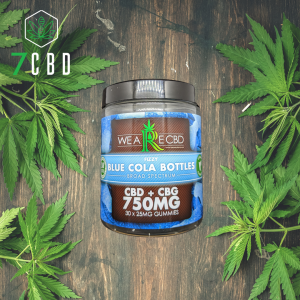 CBD Gummy tub on woodern table with hemp leaves either side